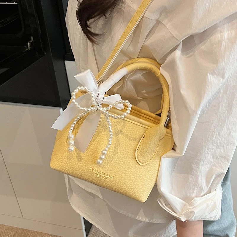 韩版小众超火水桶包包女2025新款蝴蝶结手提斜挎手机包菜篮子包包