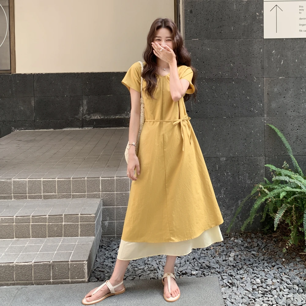 法式复古黄色V领连衣裙女2025年夏季新款慵懒氛围感网纱拼接A字裙