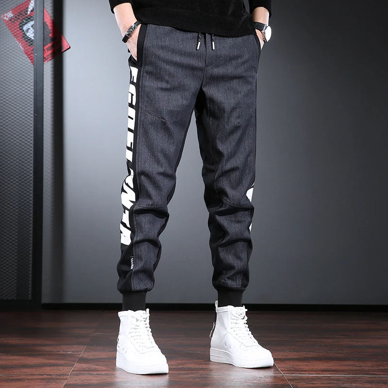 拼接休闲牛仔裤男潮牌宽松束脚裤字母印花痞帅锥形百搭哈伦裤ins