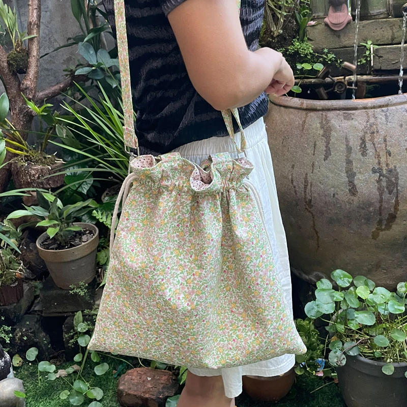新款百搭文艺清新碎花手提束口单肩斜跨包棉布袋购物袋学生书包