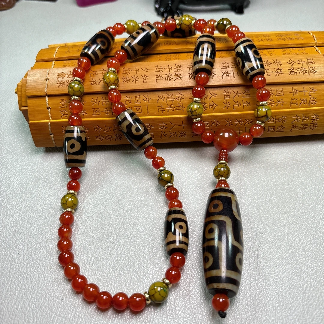 高光亮面藏地牙黄九眼珠珠项链