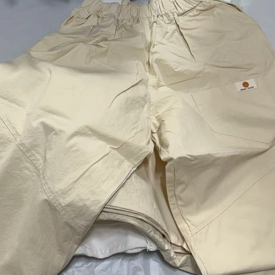 【NO退NO换】韩国东大门韩允儿2025夏款米白色笑脸小标休闲裤