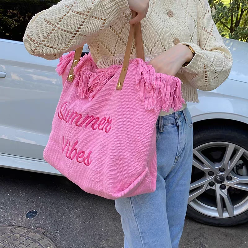 包包2025新款韩系字母流苏帆布包女大容量简约通勤学生单肩托特包