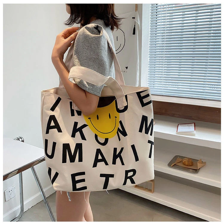 帆布包女新款印花笑脸托特包时尚手提购物袋学生上课单肩包