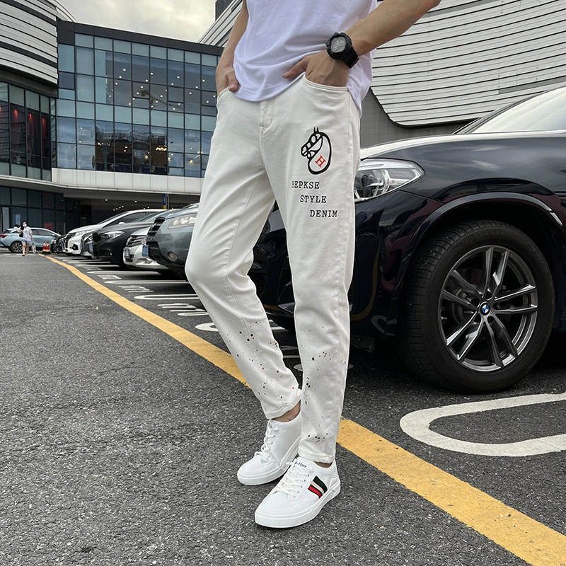 白色牛仔裤男士弹力宽松微锥显瘦印花潮流泼墨9分裤欧美舒适百搭