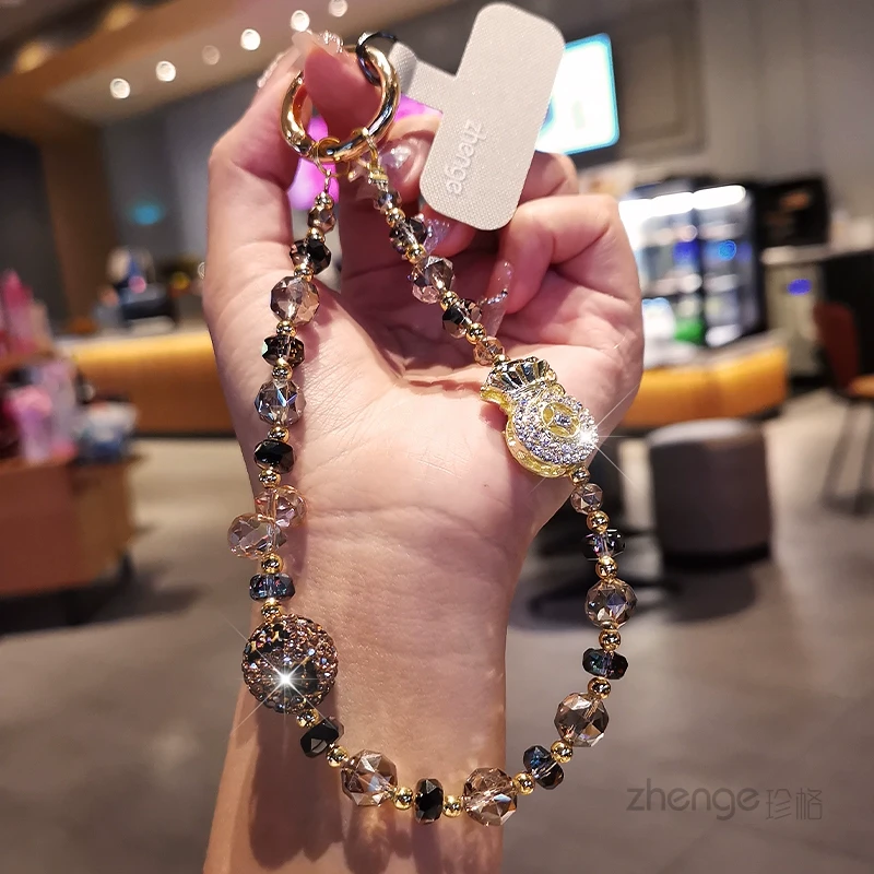 高级感水晶手机挂链招财手链镶钻钱袋串金珠挂件短款手机绳通用